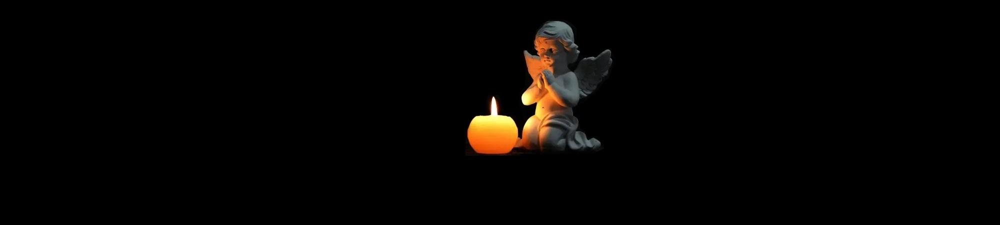 Small cherub angel kneels before lighted candle.