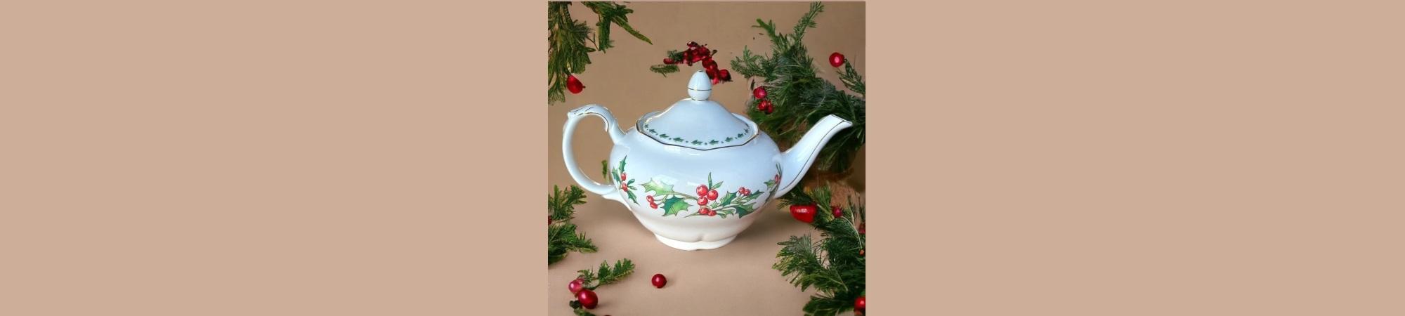 White teapot with holly leaves and red berries, a standard pattern.