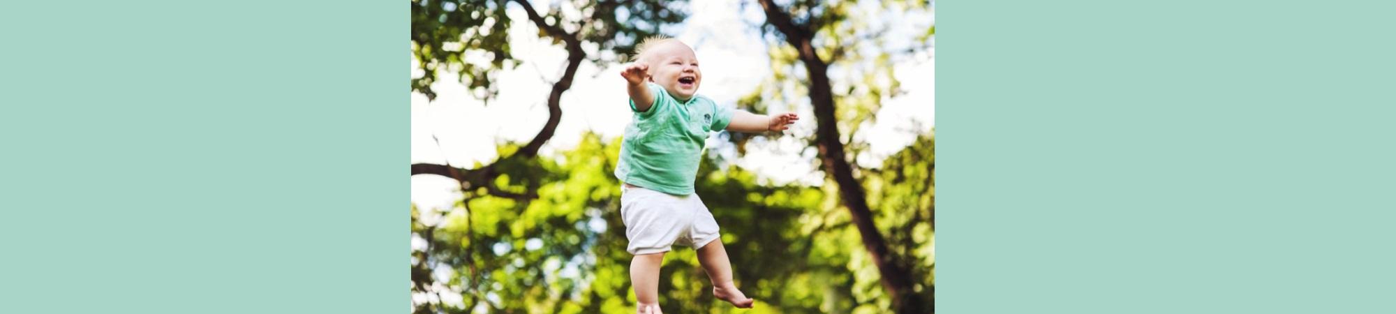 Gleeful 2-year-old boy tossed into the air. 