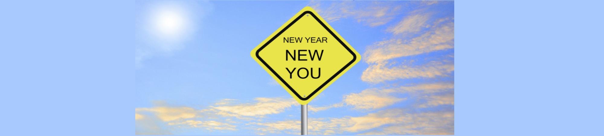 A yellow diamond-shaped traffic sign. Caution its a New Year and a New You. 