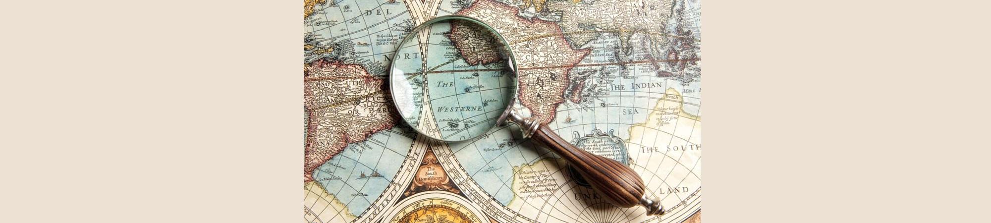 Ancient map of the world with magnifying glass