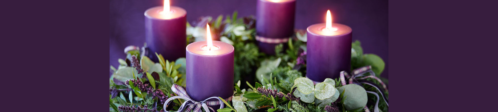 Purple candles with wreath around it
