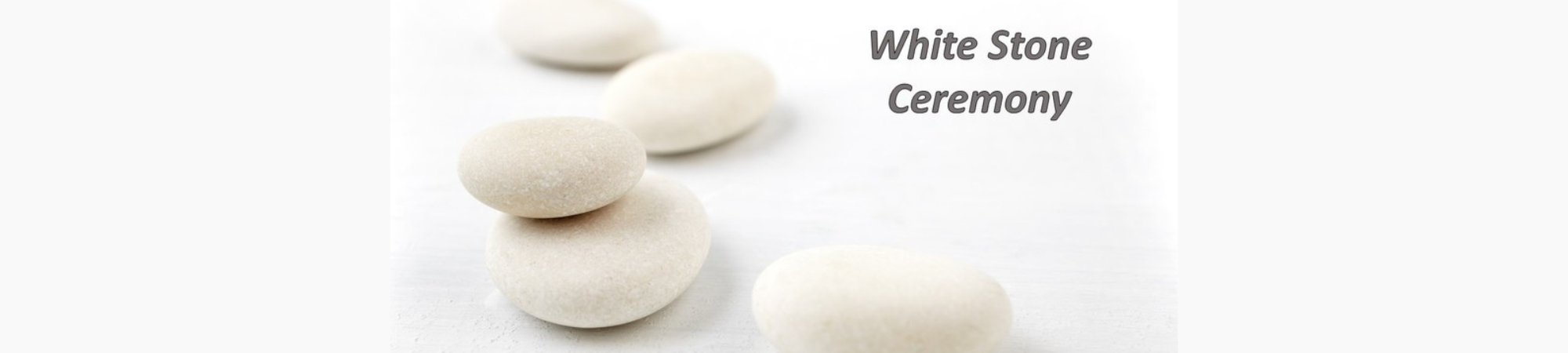 A group of smooth white stones with text, "White Stone Ceremony"