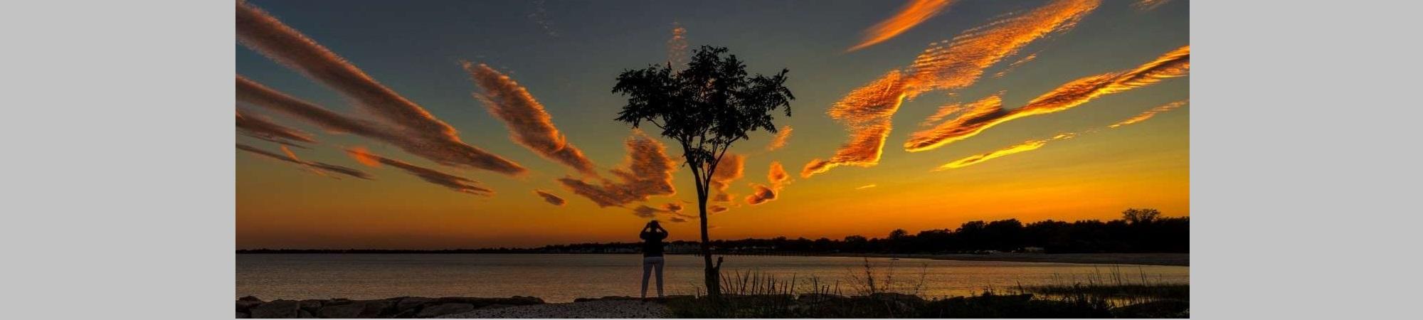 Dramatic sunset, orange clouds.